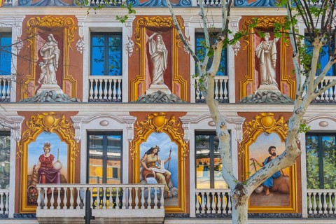 A façade painted with antique motifs on a house in Barcelona, Spain
