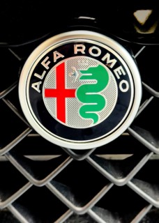 Logo on radiator grille of car brand Alfa Romeo part of parent company Stellantis, international