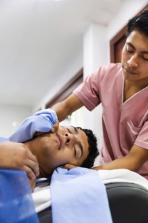A therapist provides a soothing massage to a patient in an Ecuadorian physiotherapy clinic. The