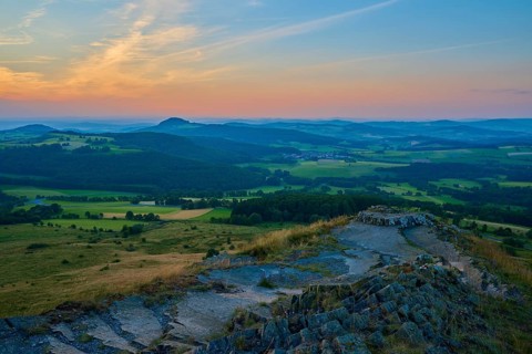 View over a hilly landscape at sunset with expansive sky and meadows, Abtsroder Kuppe, Abtsroda,
