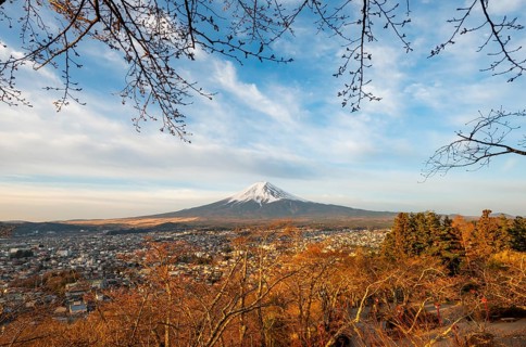 View of Mount Fuji volcano over Fujiyoshida City in morning light, at sunrise, Arakurayama Sengen