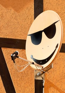Satellite dish with smiley on a house wall in Langenstein, Halberstadt, Saxony-Anhalt, Germany