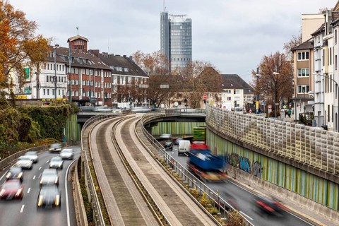 Motorway A40, Ruhrschnellweg, skyline of the city centre of Essen, exit Essen-Huttrop, track bus