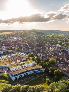 Aerial view of an idyllic small town surrounded by hills and green spaces at sunset, Weil der