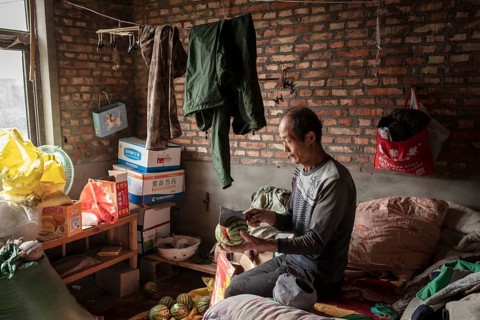 Worker Yang Zhao Bin at his sleeping place, the workers live in the respective buildings where the