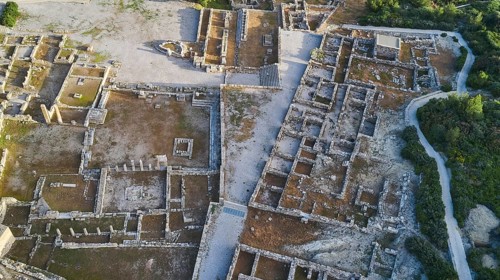 Drone image, first morning light, aerial view of a spacious ancient site with visible walls and