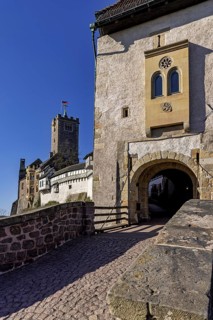 Stone bridge leads to an entrance gate next to a medieval castle, The Wartburg near Eisenach in