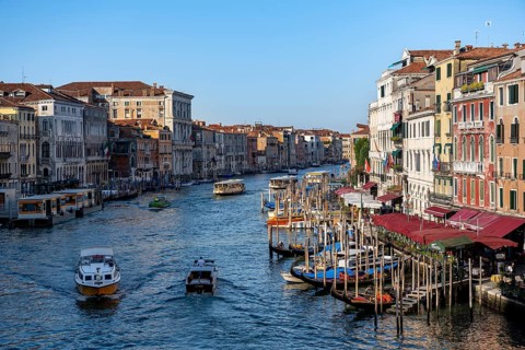 View of the Grand Canal with water taxis and vaporetto in the evening light, view from the Rialto