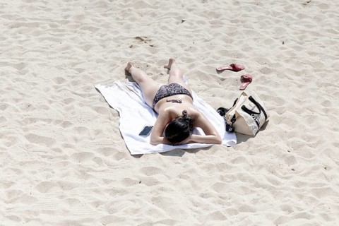 Cannes, France - 24.5.2024: People sunbathe on the beach of Cannes on the Promenade de la Croisette