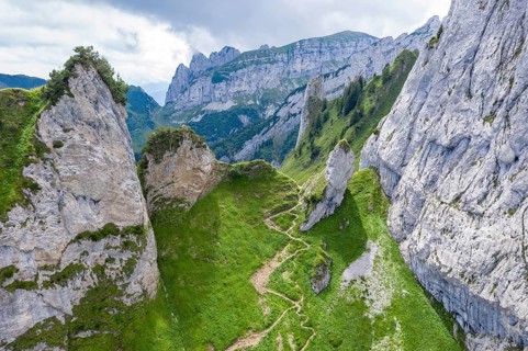 Hiking path in the Alpstein mountain range, from Wasserauen to Mesmer guest house, drone shot,