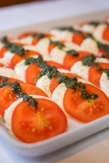 Fresh tomato slices with mozzarella and herbs on a tray, Europäischer Hof, Königsbach Stein,