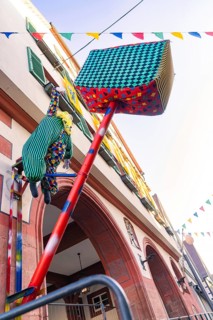 An imaginatively decorated doll figure hangs from a building in the town, Fasnet, Weil der Stadt,