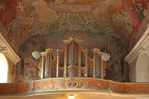 Interior view with organ and ceiling painting on the gallery of the Romanesque Mother of God Parish