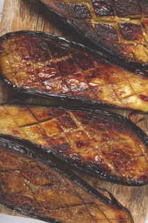 Sliced fried eggplant, on a chopping board, top view, homemade, no people