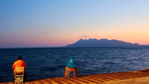 Jetty, people on chairs, dusk, Favignana Island, sunset, Levanzo, Egadi Islands, Sicily, Italy