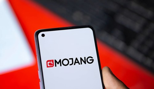 Mojang logo is displayed on smartphone. Mojang Studios is a Swedish video game developer.