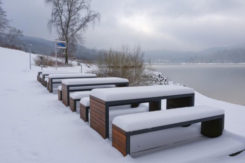 Rest area with snow-covered benches at the Hennesee, Hennetalsperre, Naturpark