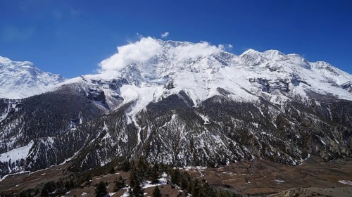 Large snowy mountains under clear skies in the natural Himalayan landscape, trekking at Annapurna