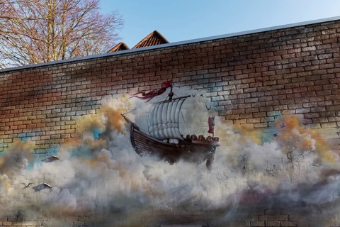 Historic sailing ship, cog, floating in a cloud, graffiti on a brick wall, Bruges, West Flanders,