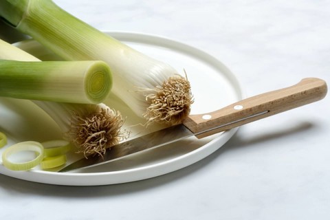Leek, leek sticks on plate with knife, leek