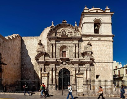 Baroque church with an elaborate stone façade under clear blue sky in Arequipa, A church in