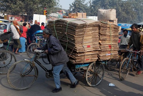New Delhi, India, 14.01.10 - A man pushes his bicycle loaded with bags, India