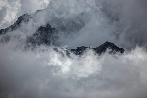 Mountain peak rises out of clouds, Canton Ticino, Switzerland