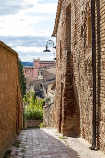 Narrow alleyways with views of the surrounding hills, old town centre of Certaldo, Tuscany, Italy