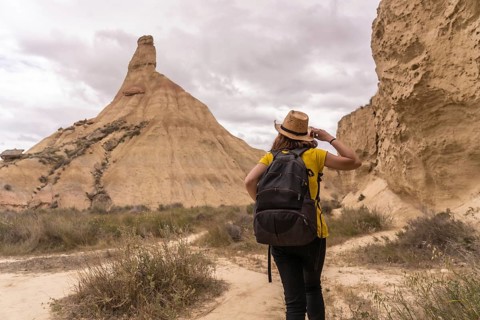 Rear view of a sportive woman strolling along a arid path in a natural reserve