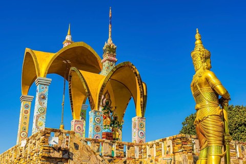 Round arch pavilions decorated with colorful mosaics and glass works of art, in front of a gilded