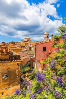 Above the roofs of Capoliveri, behind the church tower of San Michele, in front of it a purple