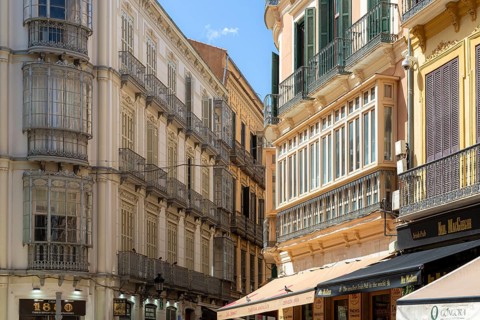 Charming street scene with historic buildings and cafés in Malaga, Spain