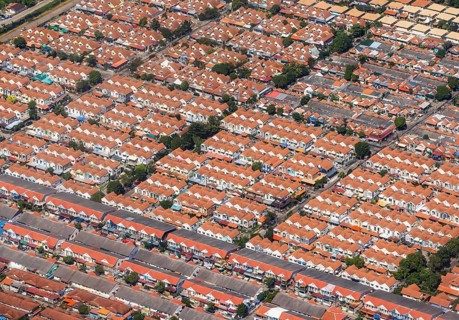 Retort city in the north-east of Bangkok. Standardised houses stand close together on the straight