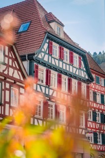 Half-timbered houses in the city with red and white shutters in spring, Calw, Black Forest, Germany