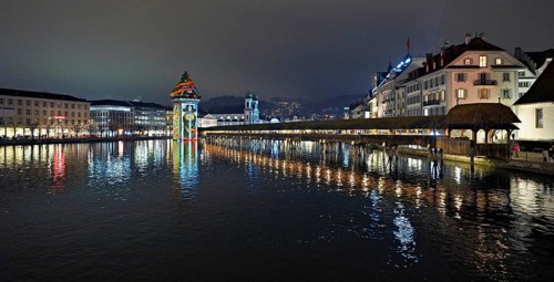 Wassertum with light installation, Chapel Bridge on the right, Jesuit Church on the Reuss at dusk