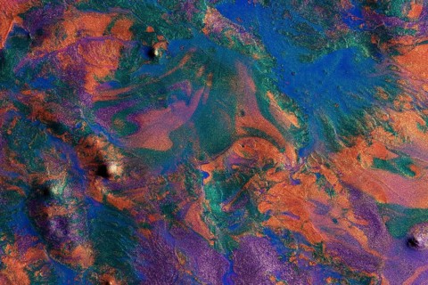 Vibrant metallic paints blend together in a chaotic yet mesmerizing pattern on this abstract