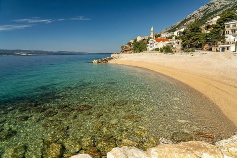 Beach and church in Pisak on the Omis Riviera, Croatia