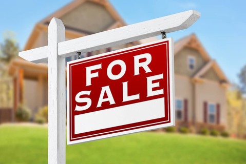 Home For Sale Real Estate Sign in Front of Beautiful New House