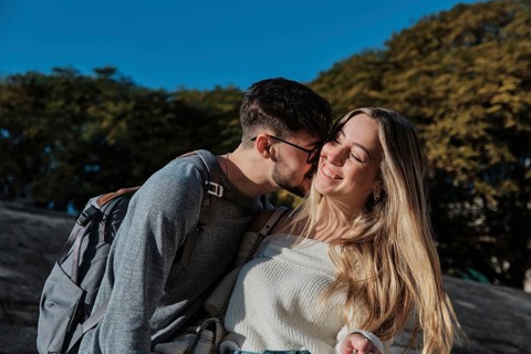 A young couple embraces while searching for their dream vacation home in Majorca, Spain. They are