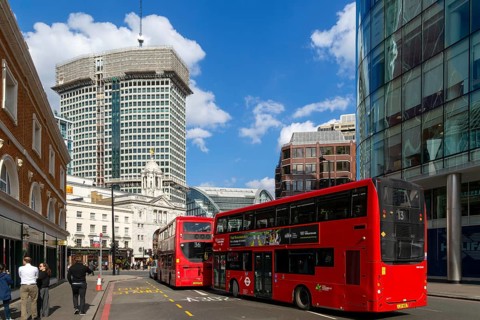 Red double-decker buses in street by Victoria palace theatre, Victoria, Westminster, London,