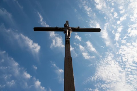 View of a cross with a statue of Christ against a cloudy sky, Wysoka Górka, Wysoka Gorka, Chelmska