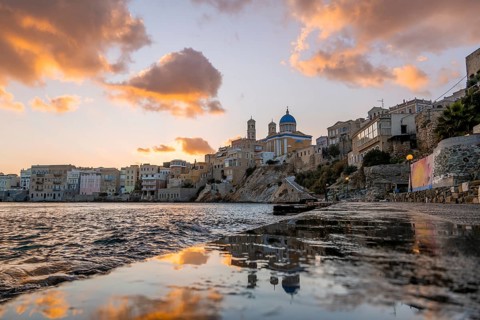 View of the village with the Greek Orthodox church of Agios Nikolaos, Asteria Beach, at sunset with