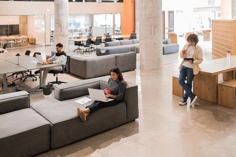 A contemporary open office space with professionals engaged in various tasks The environment