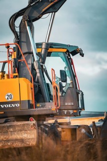 Yellow Volvo tracked excavator on construction site