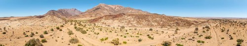 Aerial view, dry riverbed and desert landscape on the Ugab River, behind Brandberg, Erongo,