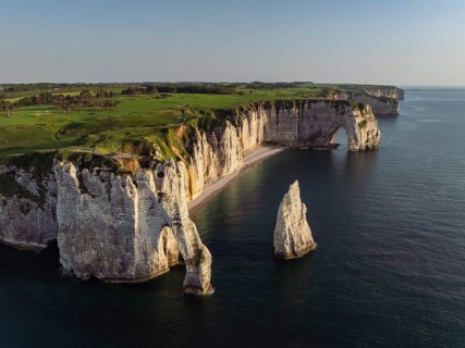 Aerial view of the Porte d'Aval rock formation in the evening sun, well-known sights on the chalk