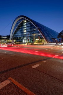 BBCC Berliner Bogen Conference Center at blue hour with light strips of vehicles in the foreground,