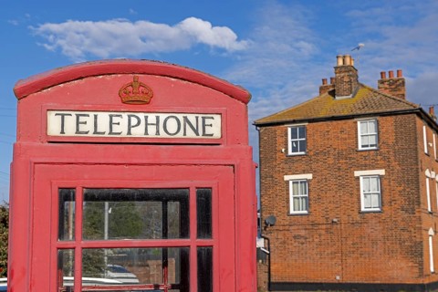 Traditional red telephone box, house, Harwich, England, United Kingdom