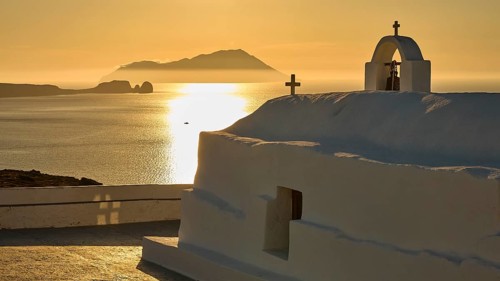 Panagia Tourliani, church, white building with crosses on the sea at sunset, an island in the
