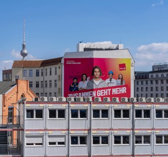 Oversized Verdi advertisement on a house façade on Schiffbauerdamm, Berlin, Germany